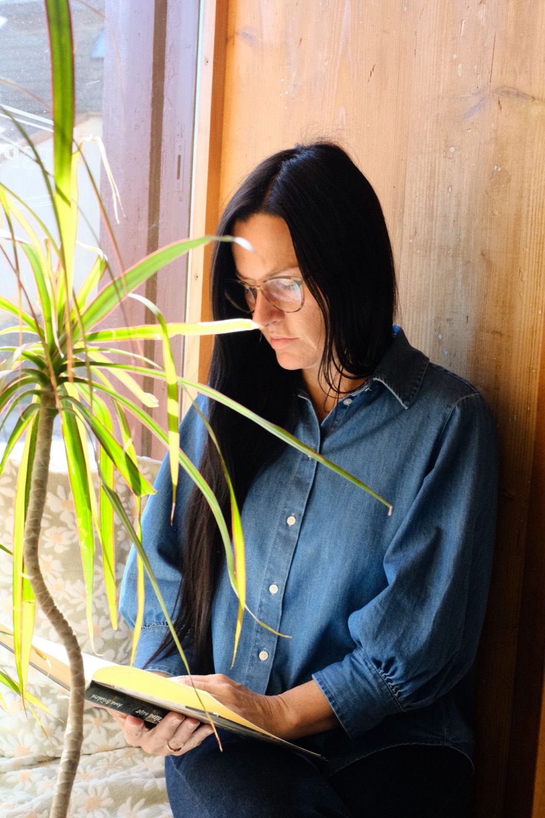 Diana reading by a window in natural light